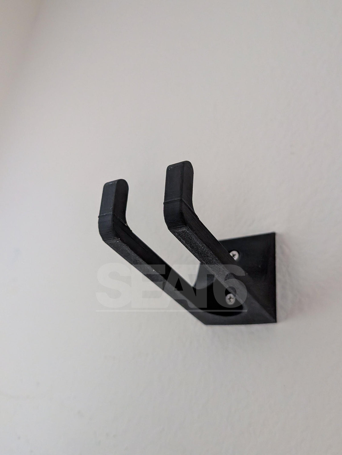 Paddle Wall Hook holding outrigger paddles on a wall